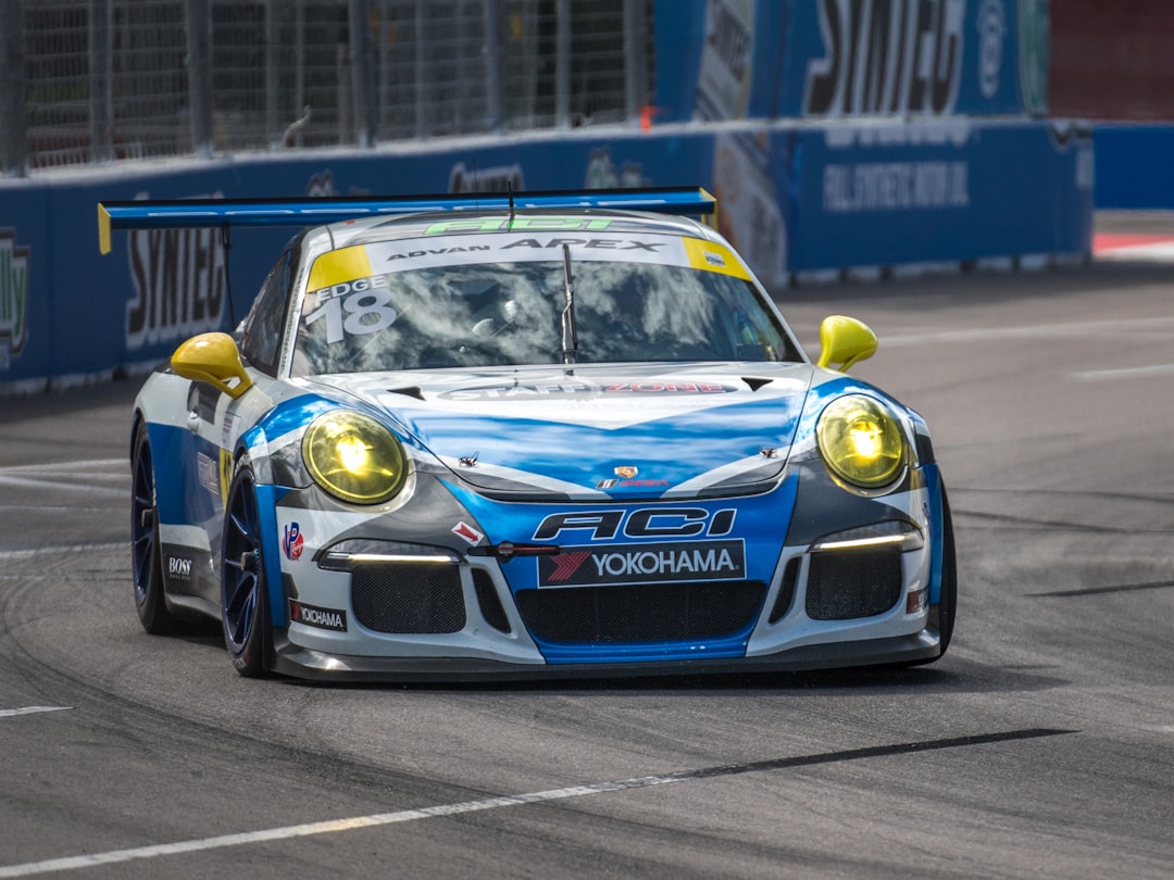 blue and yellow porsche 911 on road during daytime